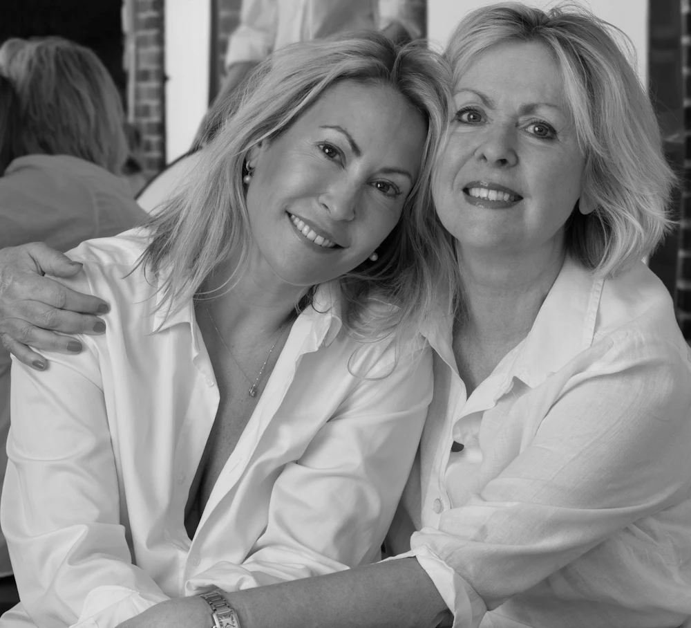 Two smiling women in their forties and fifties