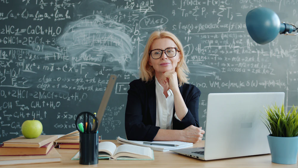 A focused woman in her fifties working at her desk
